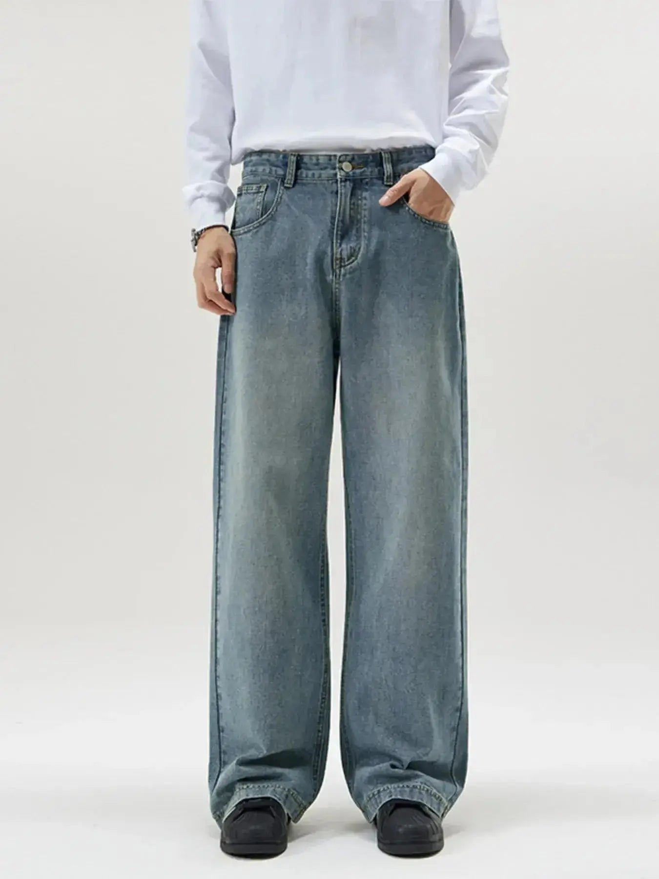 Men's vintage wash wide-leg jeans by Trendsi featuring relaxed fit, retro denim style, shown on a male model.