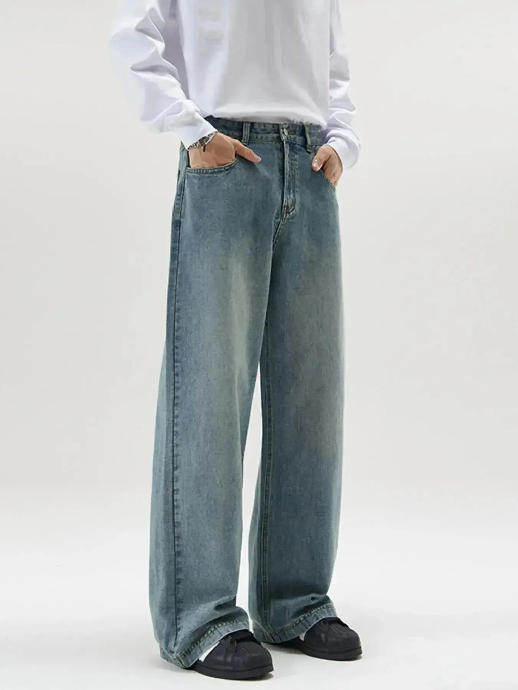 Men's vintage wash wide-leg jeans by Trendsi featuring relaxed fit retro denim style, shown on a model.