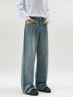 Men's vintage wash wide-leg jeans by Trendsi featuring relaxed fit retro denim style, shown on a model.