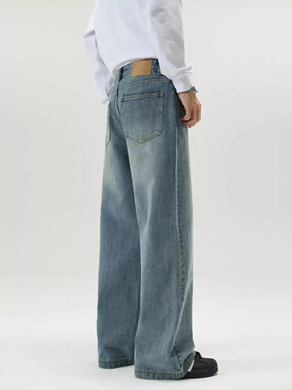 Men's vintage wash wide-leg jeans with relaxed fit and retro denim style, featuring classic denim texture and casual design.