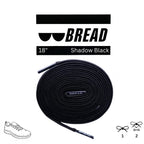 Black elastic shoelaces from Bread's Shadow Black collection, shown in a close-up image highlighting their stretchy, durable design.
