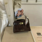 Premium suede mini crossbody bag with adjustable leather strap from Plush Fashion Hub, featuring a sleek compact design.