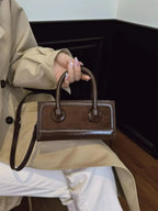 Premium leather top-handle crossbody bag by Plush Fashion Hub, structured versatile handbag with sturdy top handle and sleek design.