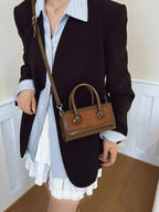 Premium leather top handle crossbody bag by Plush Fashion Hub, showcasing its structured design and versatile style.