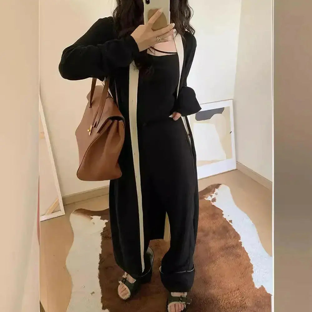 Women’s black long sleeve knitted A-line dress from Plush Fashion Hub, soft, versatile midi design for stylish comfort.