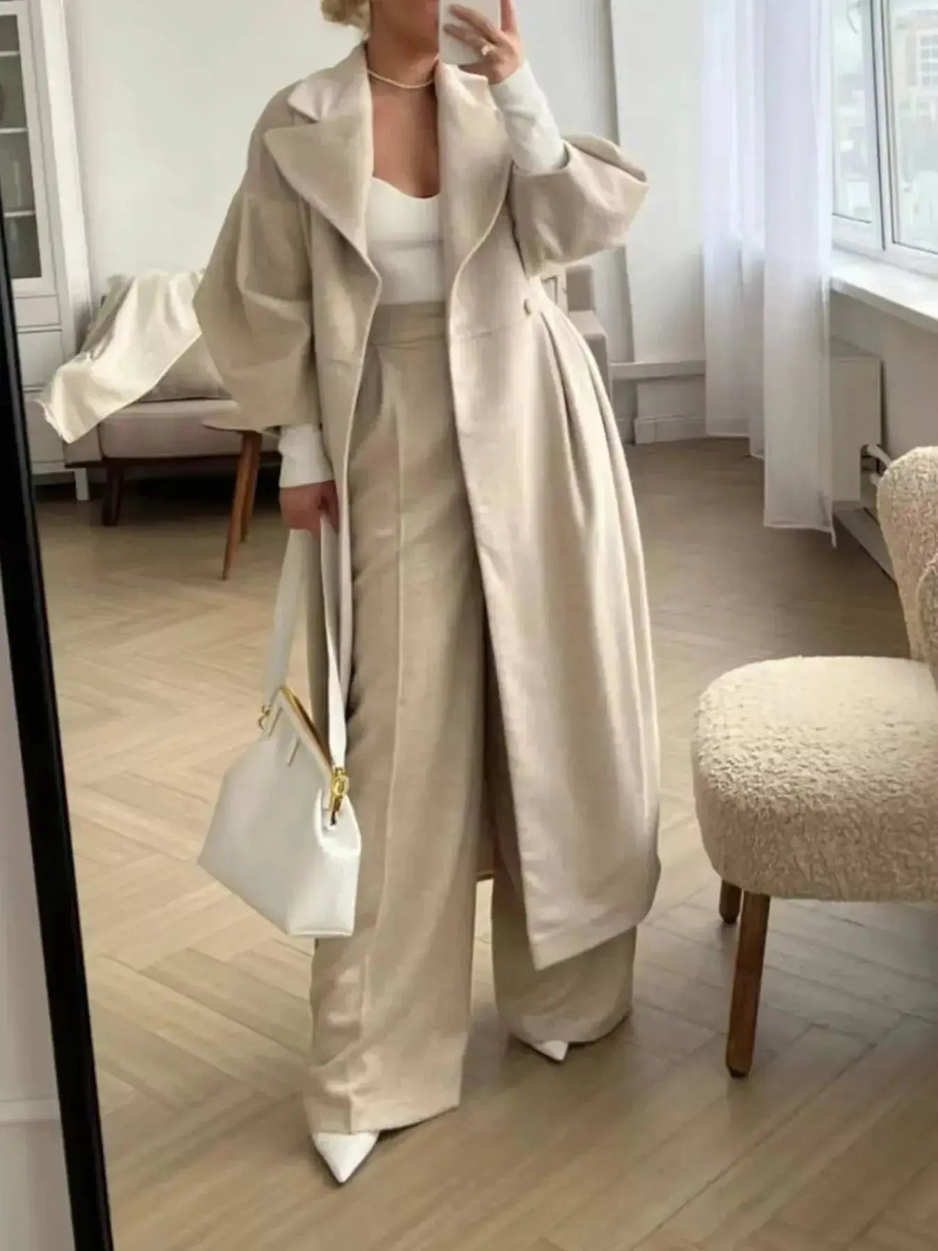 Women's double-breasted longline coat with ruched detailing, stylish and warm outerwear from Trendsi.