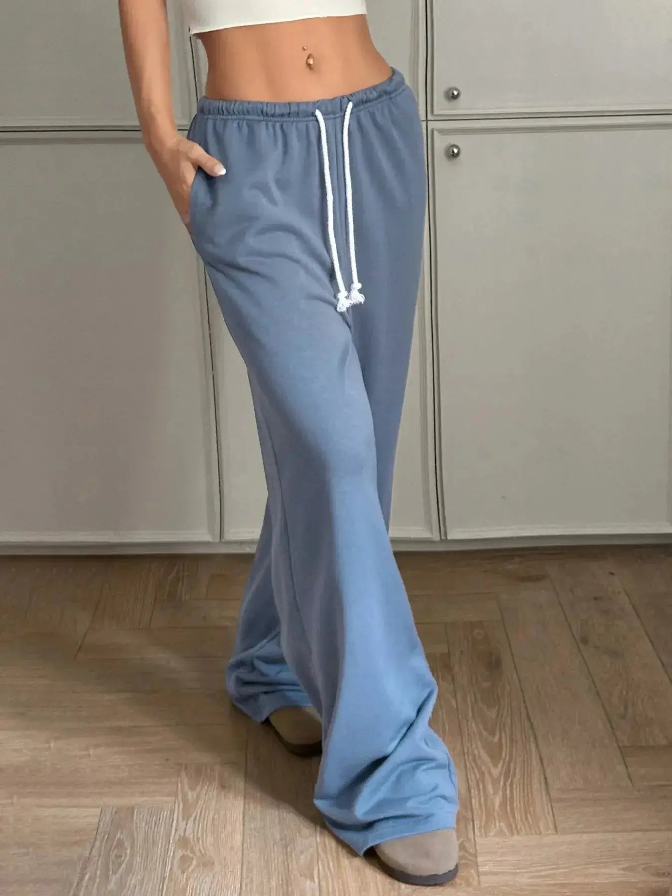 Women's high-waisted wide-leg drawstring pants with pockets, trendy and comfortable, by Trendsi.