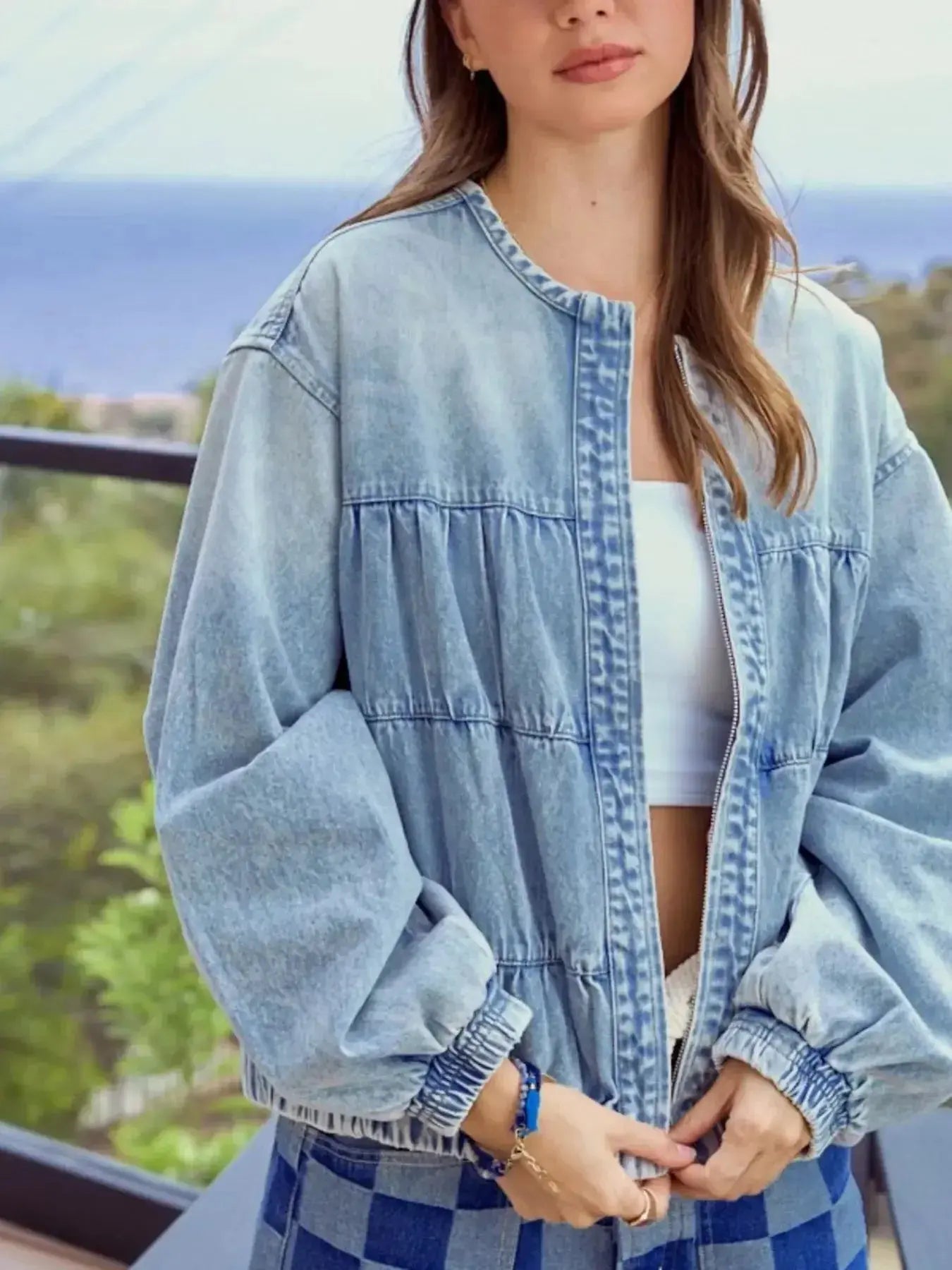 Women’s vintage washed zip-up denim jacket by Trendsi, structured cotton blend fabric, shown on model with front view.
