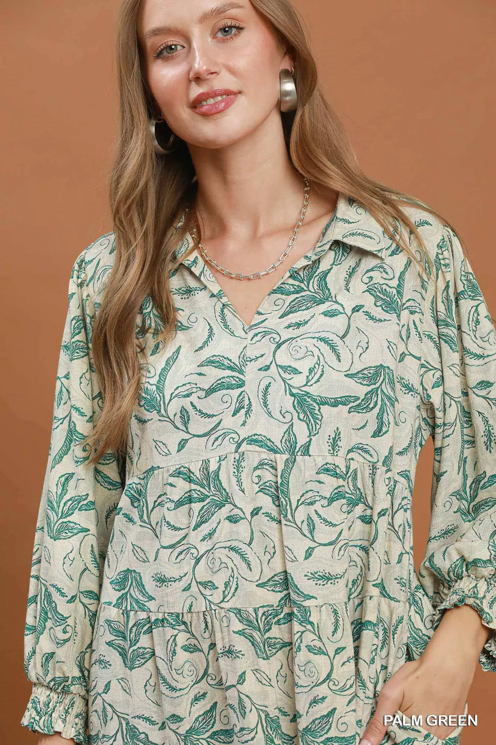 Light linen botanical print tiered midi dress by Umgee featuring a flowy silhouette and soft fabric for a relaxed, summery look.