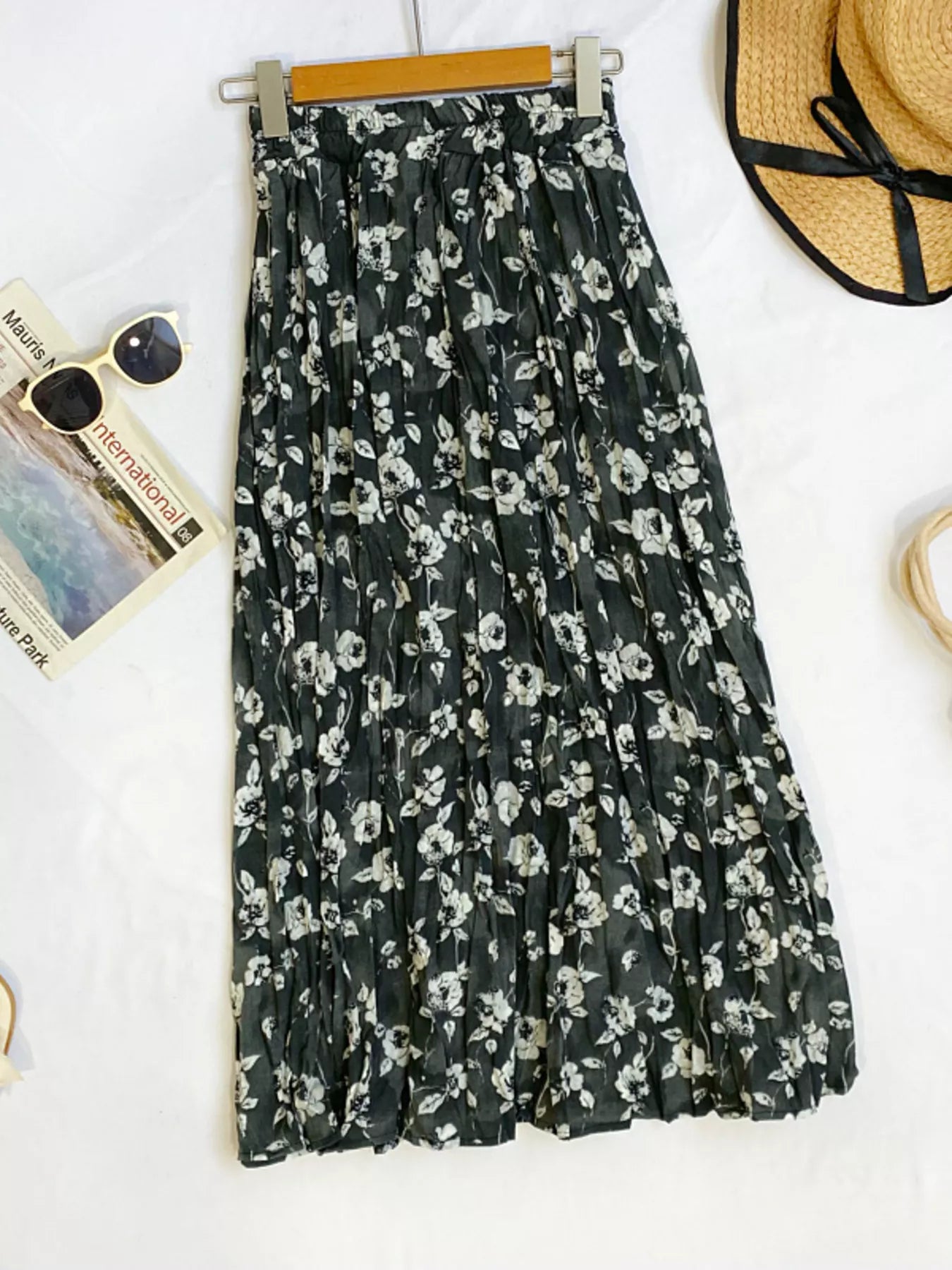 Floral print elastic waist midi skirt from Trendsi, flowing fabric with vibrant flower patterns, stylish and comfortable for everyday wear.