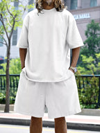 Plus size men's relaxed fit T-shirt and shorts set by Trendsi, featuring a casual, comfortable design and soft fabric.