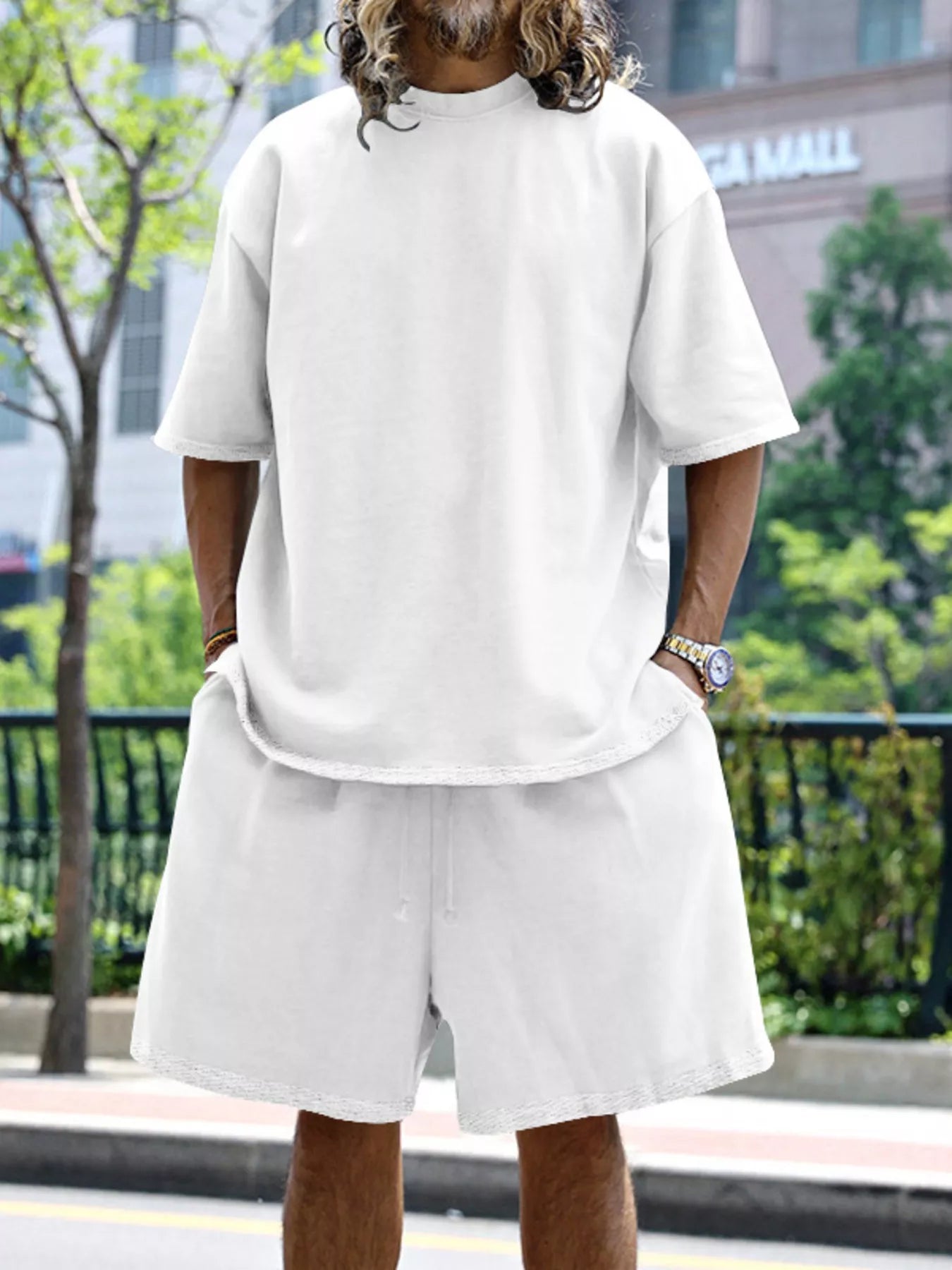Plus size men's relaxed fit T-shirt and shorts set by Trendsi, featuring a casual, comfortable design and soft fabric.