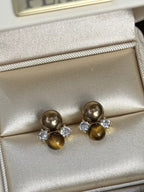 Tiger Eye stud earrings by Trendsi featuring polished, round gemstone studs with gold-tone settings.