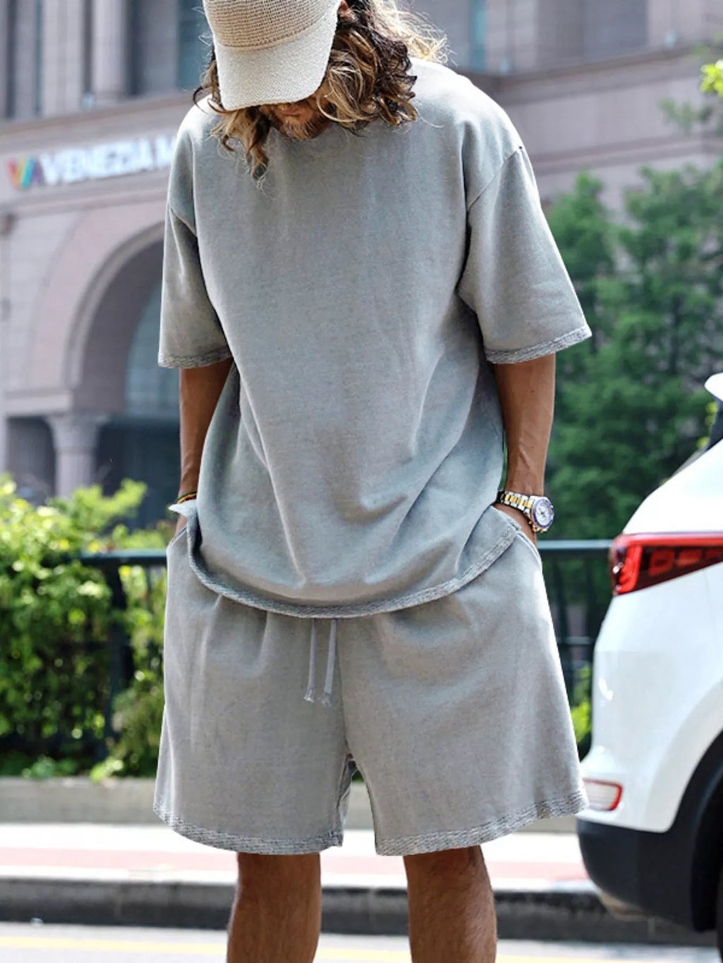 Men's relaxed fit T-shirt and shorts set in plus size, casual outfit by Trendsi, shown in a comfortable, relaxed style.
