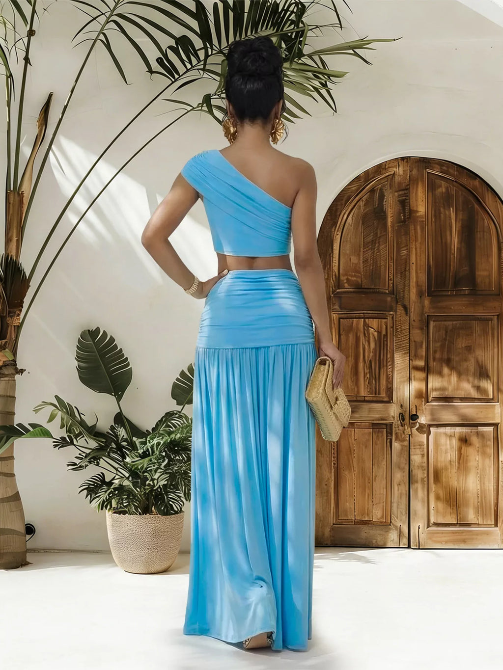 Trendsi one-shoulder top and ruched maxi skirt set displayed on a model, showcasing stylish, coordinated fashion ensemble.
