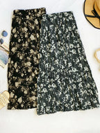 Floral print elastic waist midi skirt by Trendsi, featuring a flowy design with colorful flower patterns and comfortable fit.
