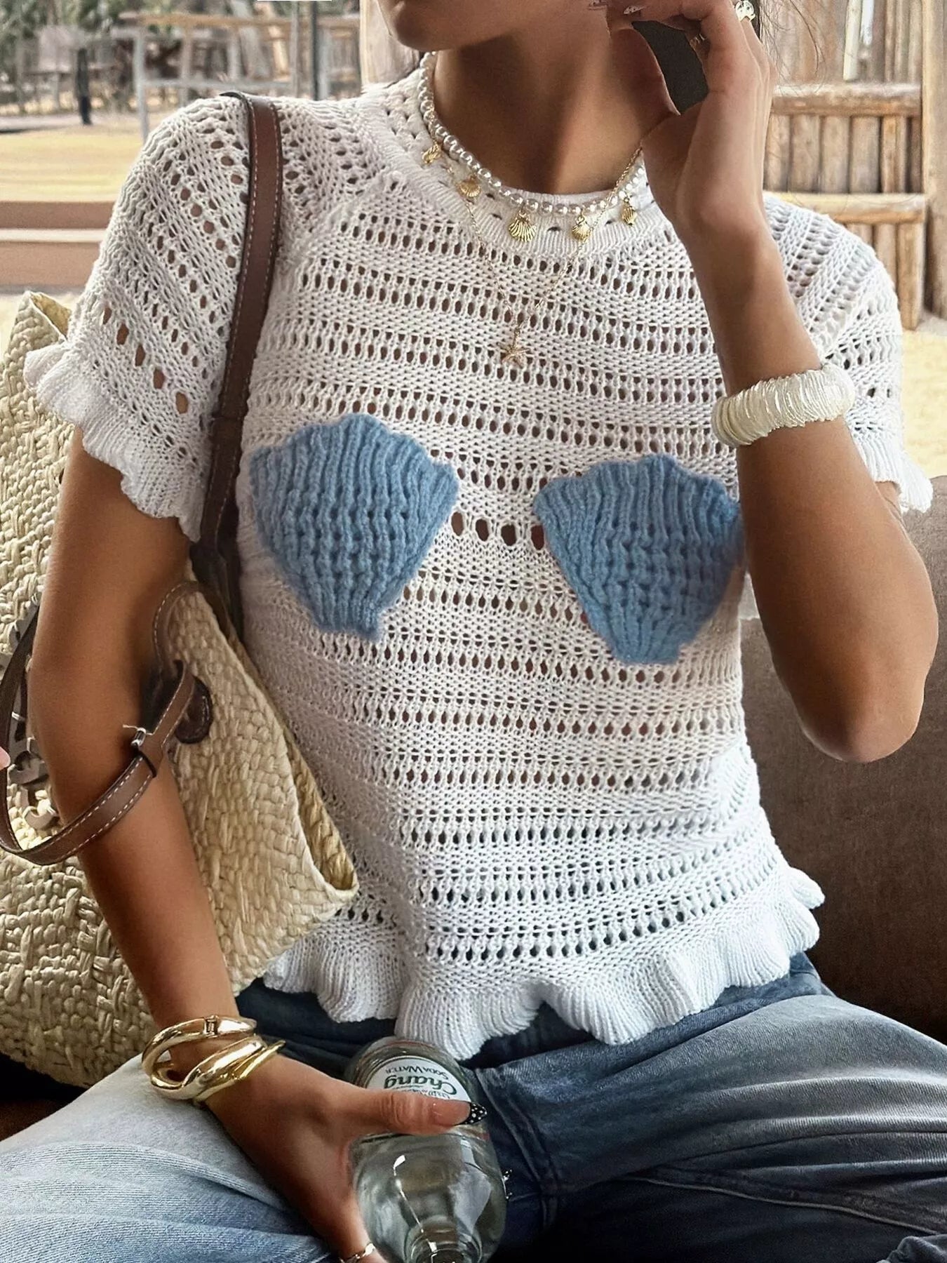 Openwork ruffled hem knit top by Trendsi, featuring a lightweight, textured fabric with ruffle details at the hem.