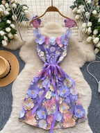 Floral embroidered tie waist mini dress by Trendsi featuring an elegant summer A-line silhouette and vibrant floral details.