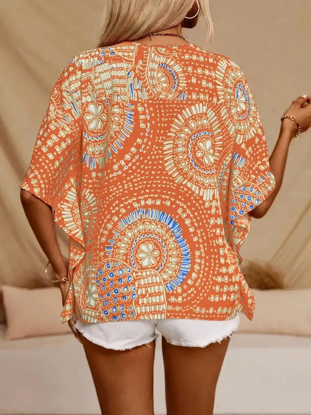 Women's printed V-neck casual top by Trendsi, soft stretch fabric, half sleeves, perfect for office or casual wear.