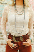 Sheer floral mesh long sleeve top with ruched details, stylish trendy blouse for fashion-forward outfits.