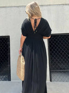 Plus size Trendsi maxi dress with slit V-neck, smocked waist, full length, and flowy fabric in a stylish, elegant design.
