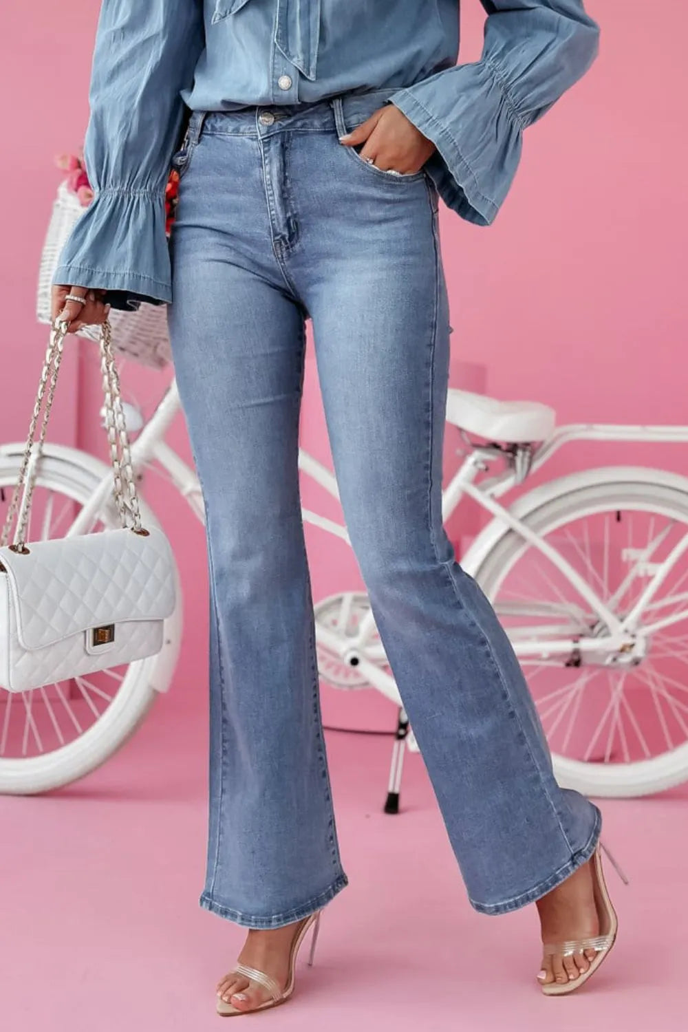 Trendsi bootcut jeans with front and back pockets, classic denim style, and a relaxed fit, shown on a model.