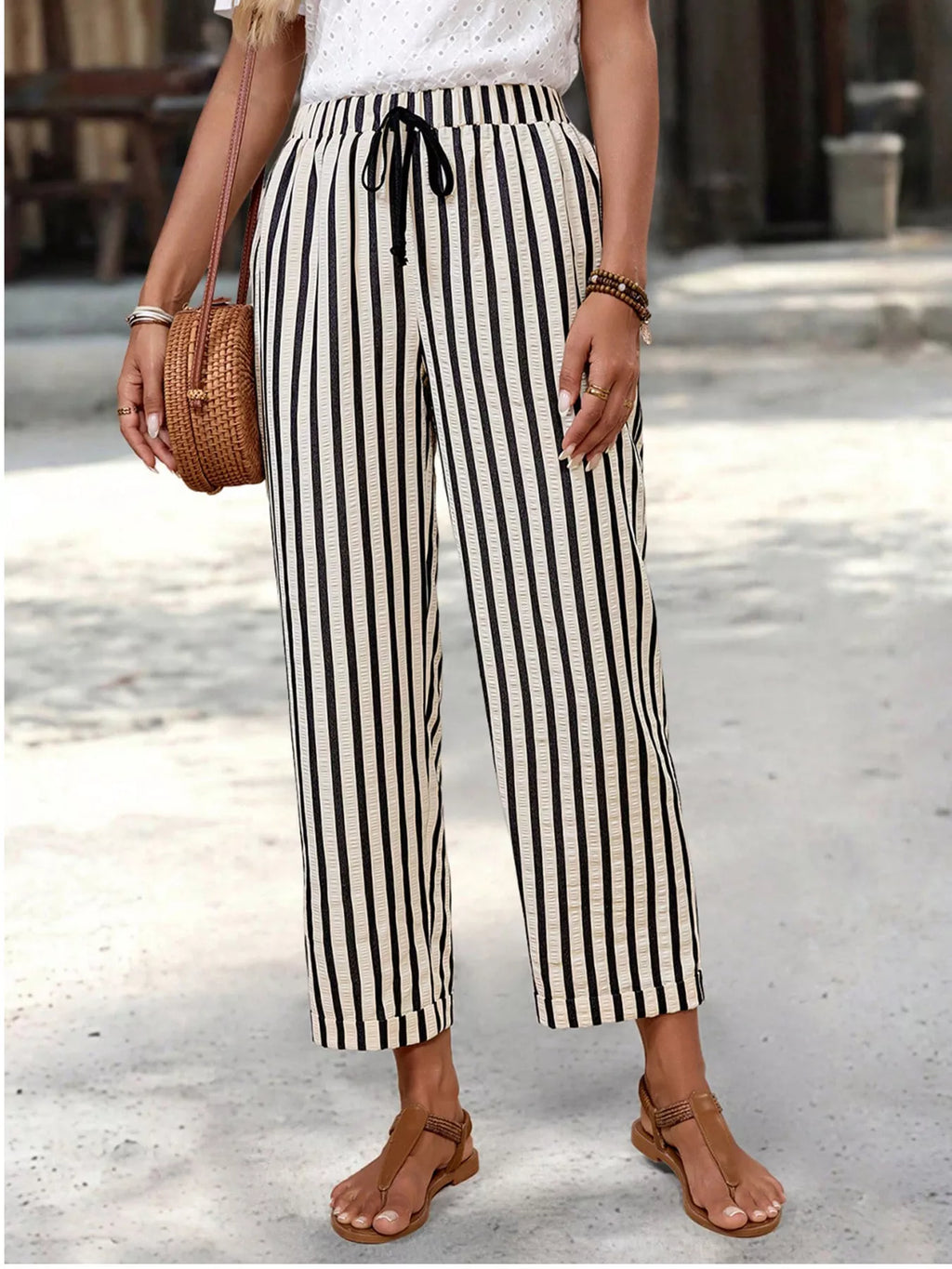 Women's striped high-waisted cropped pants with pockets, featuring a trendy design and comfortable fit from Trendsi.