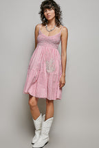 Women's sleeveless striped smocked embroidered cotton mini dress by Trendsi, featuring colorful patterns and a casual summer style.