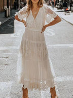 Elegant bohemian lace maxi dress with short sleeves, flowing plus size gown by Trendsi. Perfect for stylish, comfortable wear.