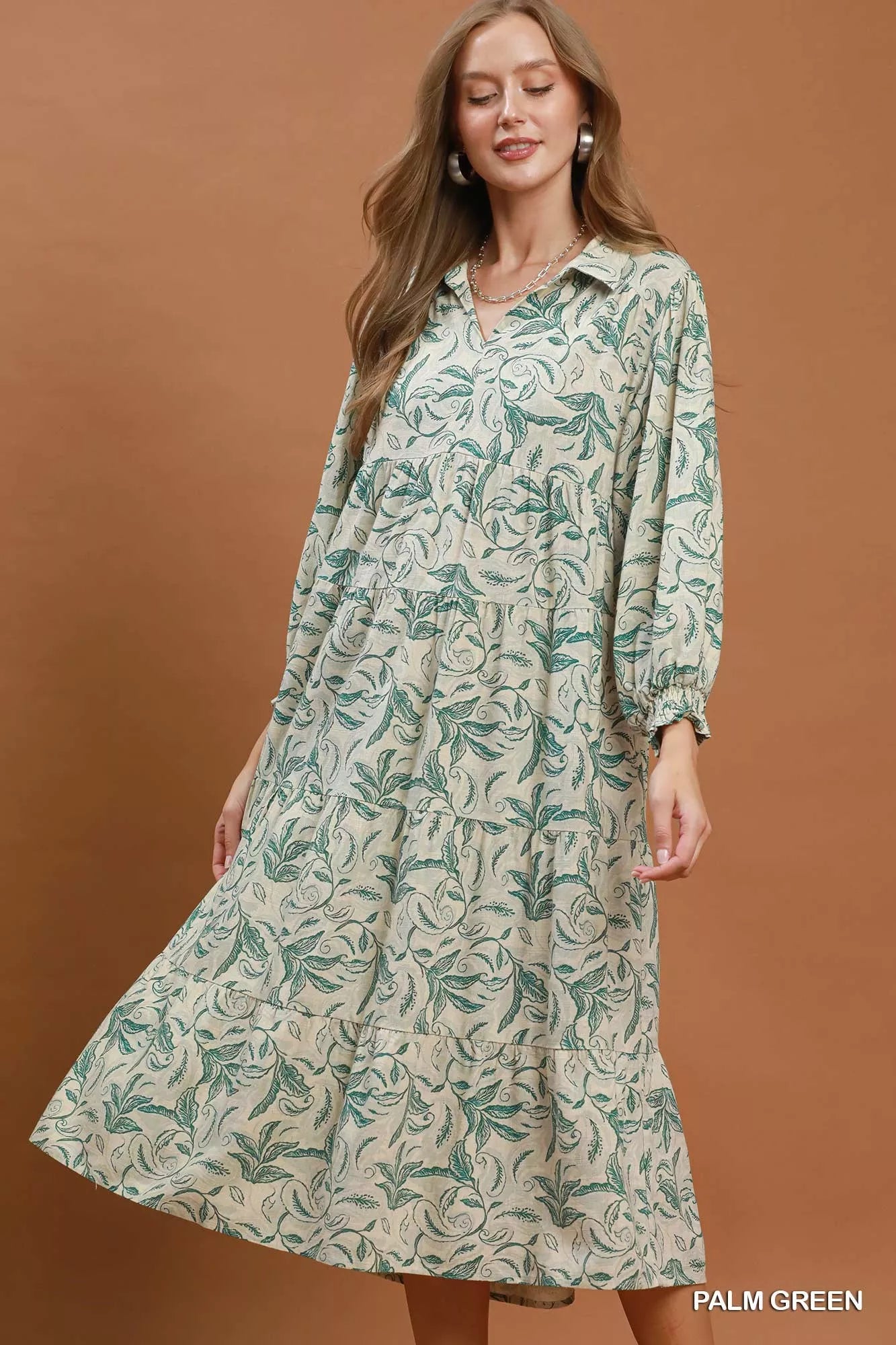 Umgee linen botanical print tiered midi dress with flowy fabric and sleeveless design, perfect for warm weather and casual occasions.