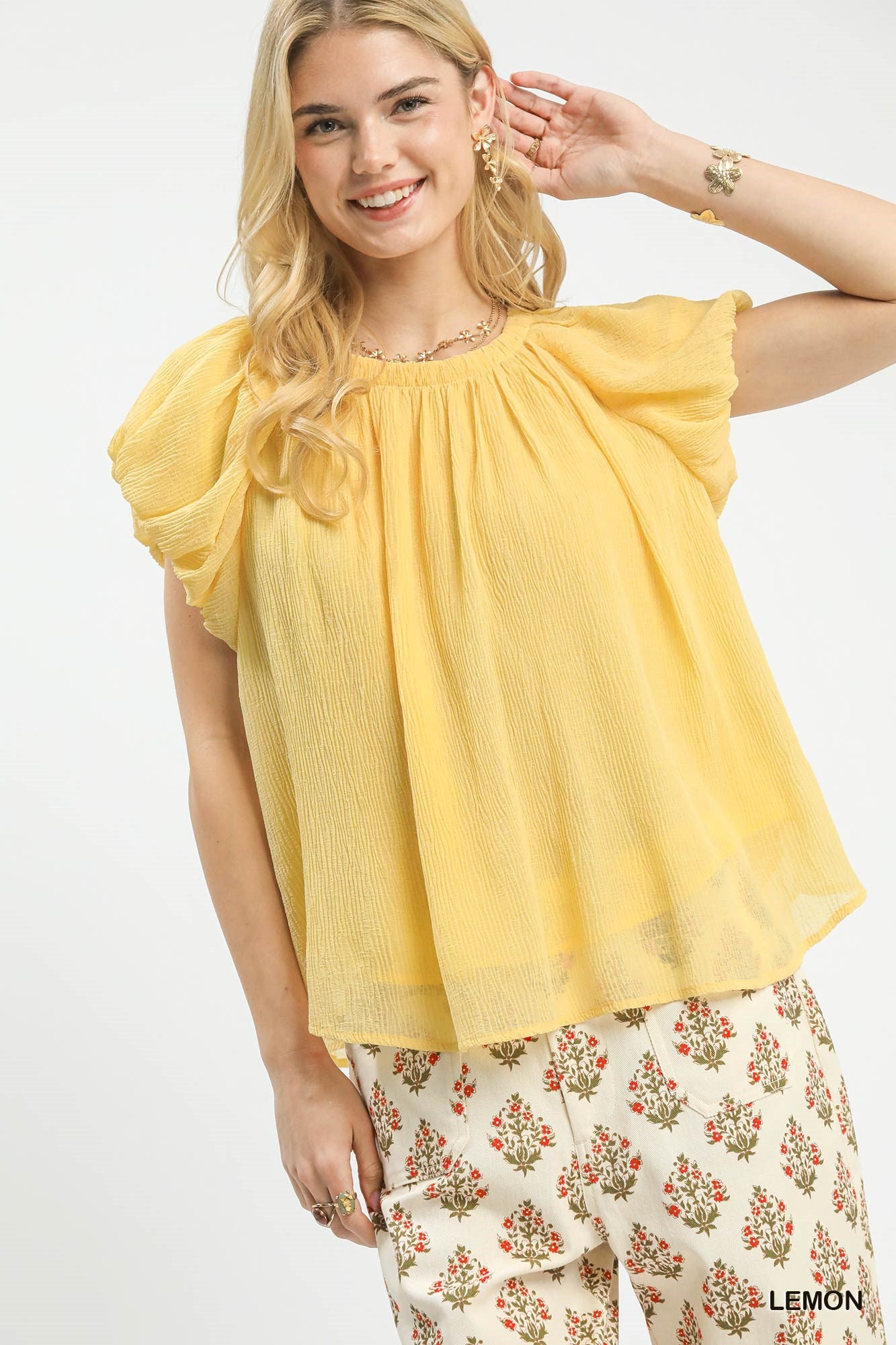 Women's crinkle flutter sleeve peasant blouse by Trendsi, casual boho top with lightweight fabric and relaxed fit.