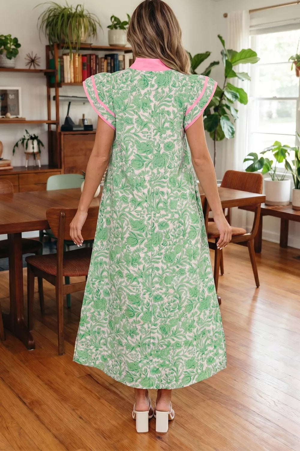Floral midi dress with contrast trim and flutter sleeves from Trendsi, showing the dress's flowy fabric and vibrant floral pattern.