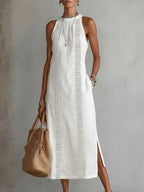 Sleeveless hollow-out midi dress with side slit and pockets by Trendsi, showcasing the stylish design and fabric details.