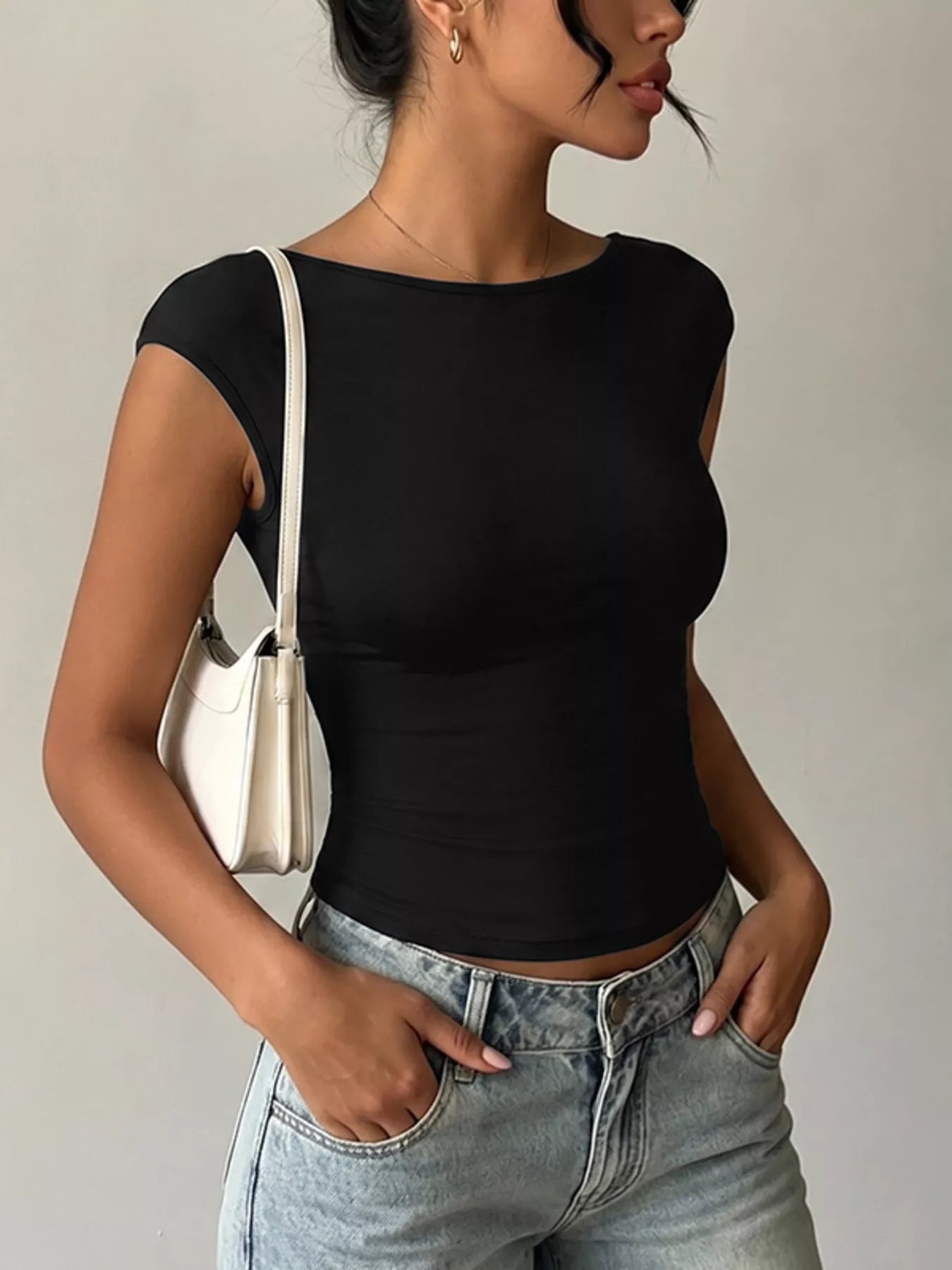 Lace detail cap-sleeve T-shirt by Trendsi, featuring a soft fabric with elegant lace accents on the sleeves and neckline.