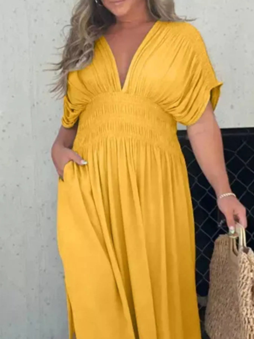 Plus size full-length maxi dress with slit, V-neck and smocked waist from Trendsi, featuring a flowing fabric and elegant design.