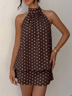 Polka dot halter neck mini dress by Trendsi, featuring a stylish design with a fitted bodice and playful pattern.