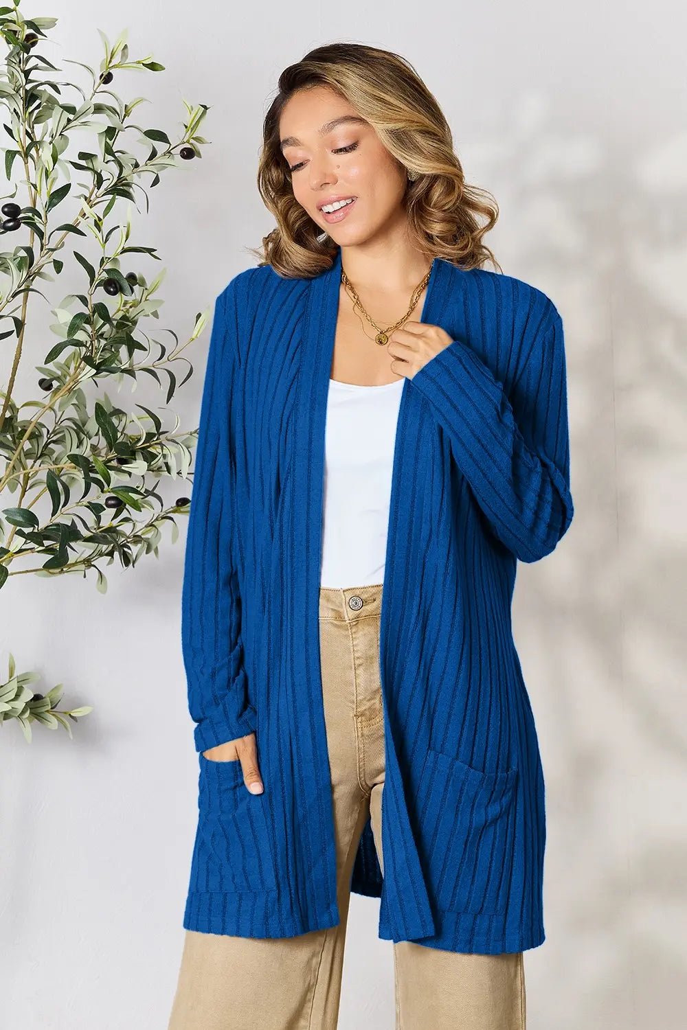 Women's ribbed open front cardigan with functional pockets, lightweight and cozy, from Trendsi in neutral knit fabric.