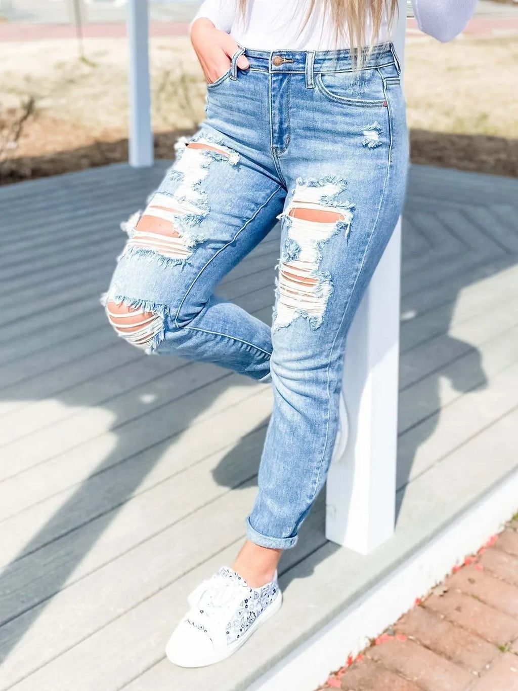 Distressed skinny jeans by Trendsi featuring a fitted style with ripped details and a casual, trendy look.