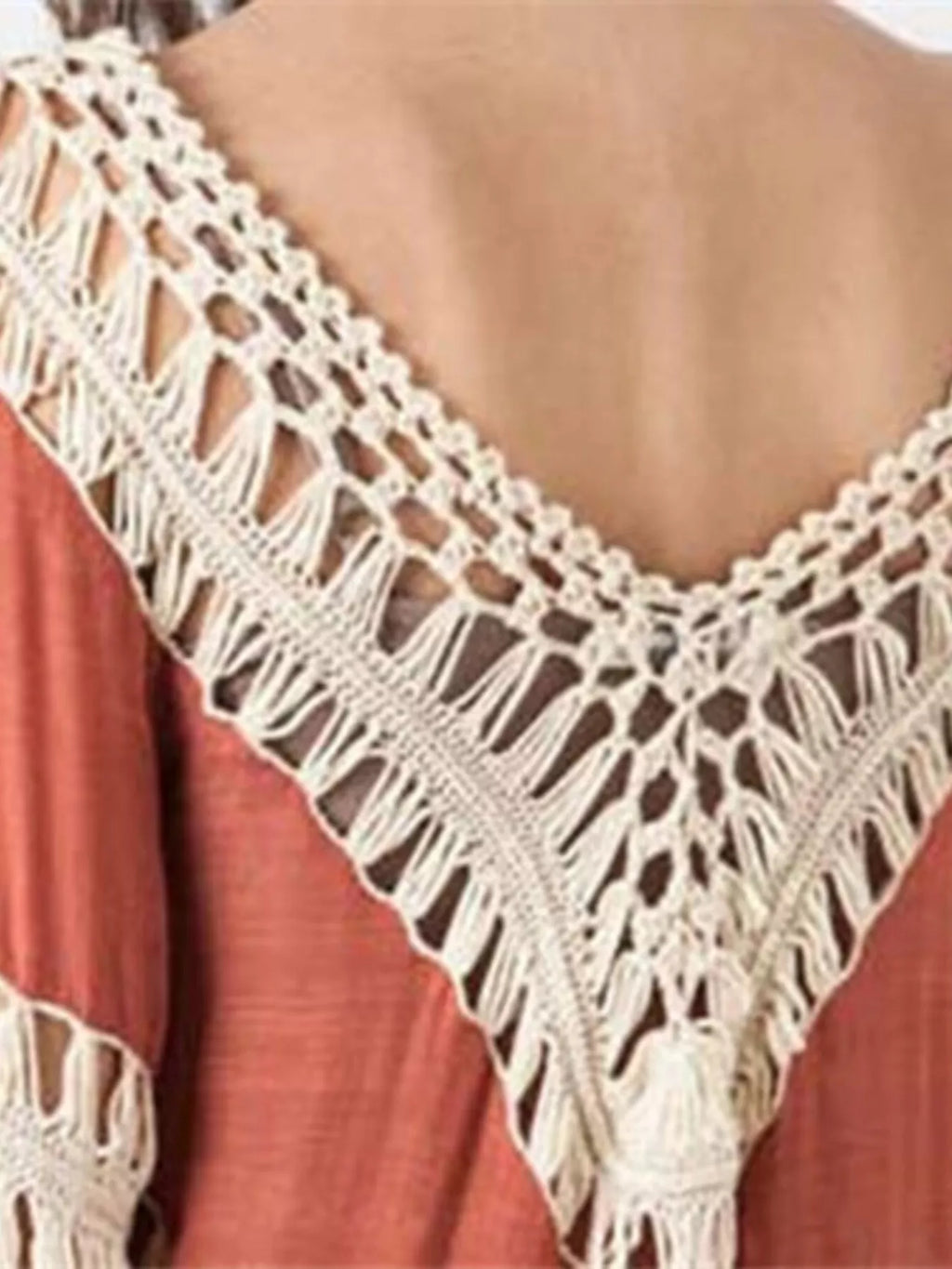 Crochet-trimmed long sleeve cover-up by Trendsi, lightweight beachwear with intricate crochet details and flowing fabric.