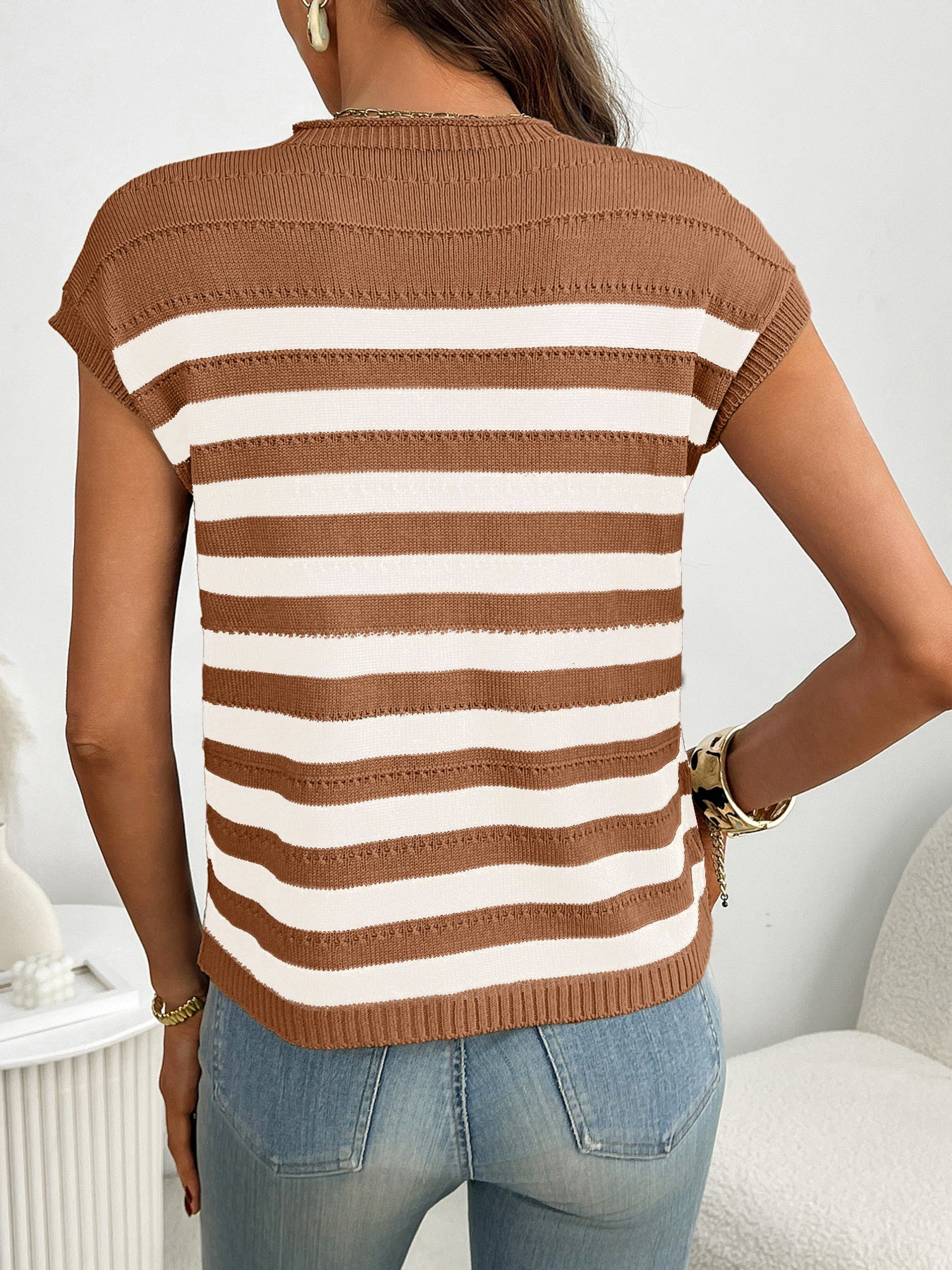 Women's striped knit cap sleeve sweater with pocket detail, trendy and cozy, featuring a stylish design and comfortable fit.