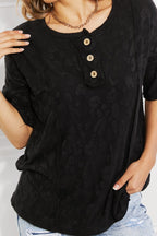 Black women's animal textured half-sleeve top by Trendsi, soft stretch casual tee with stylish pattern and comfortable fit.