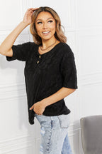 Women's black animal-textured half-sleeve top by Trendsi, featuring a soft stretch casual tee with stylish animal pattern.