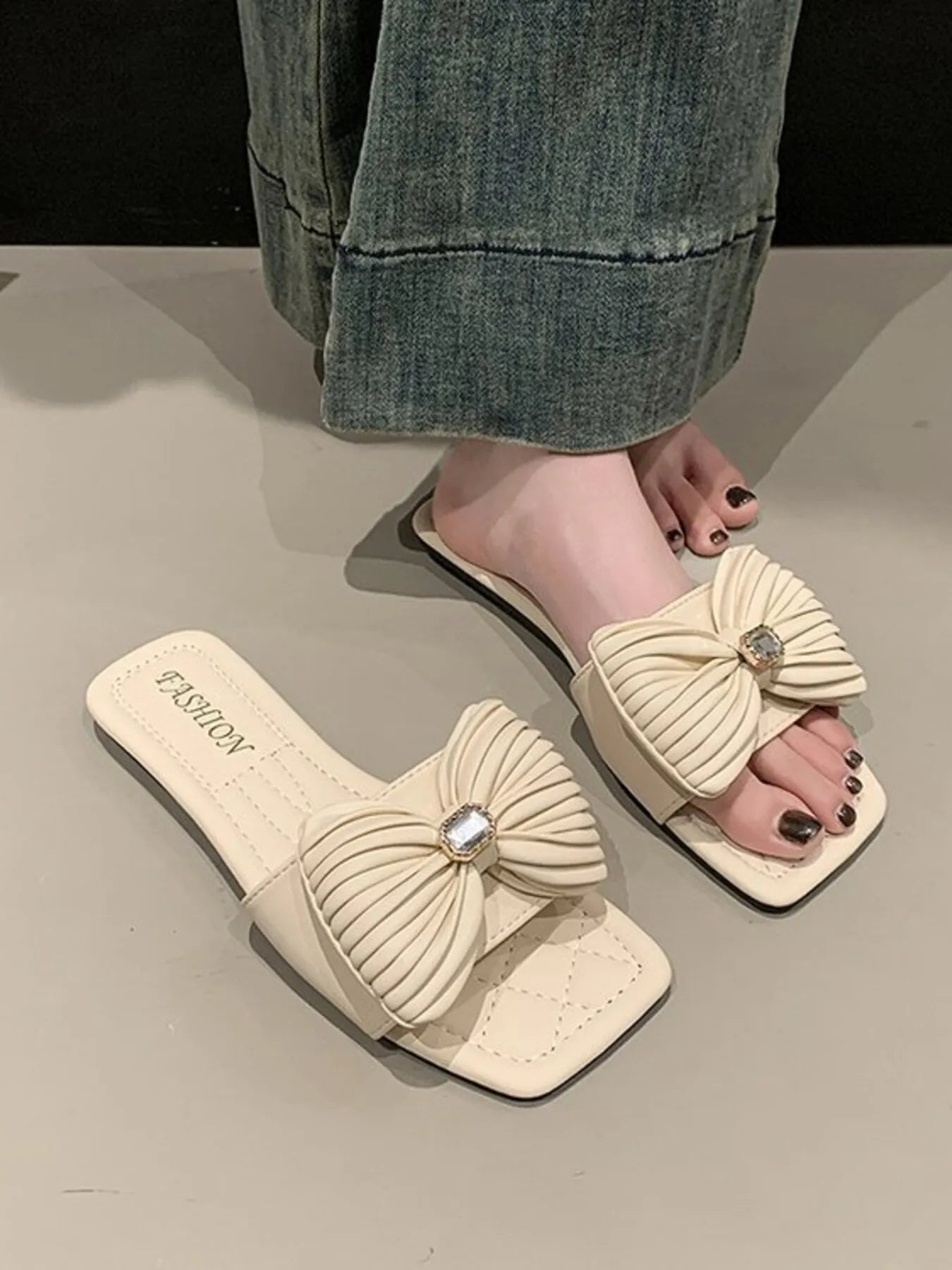 Women's elegant faux leather flat sandals with bow-knot detail, stylish and comfortable shoe from Trendsi.
