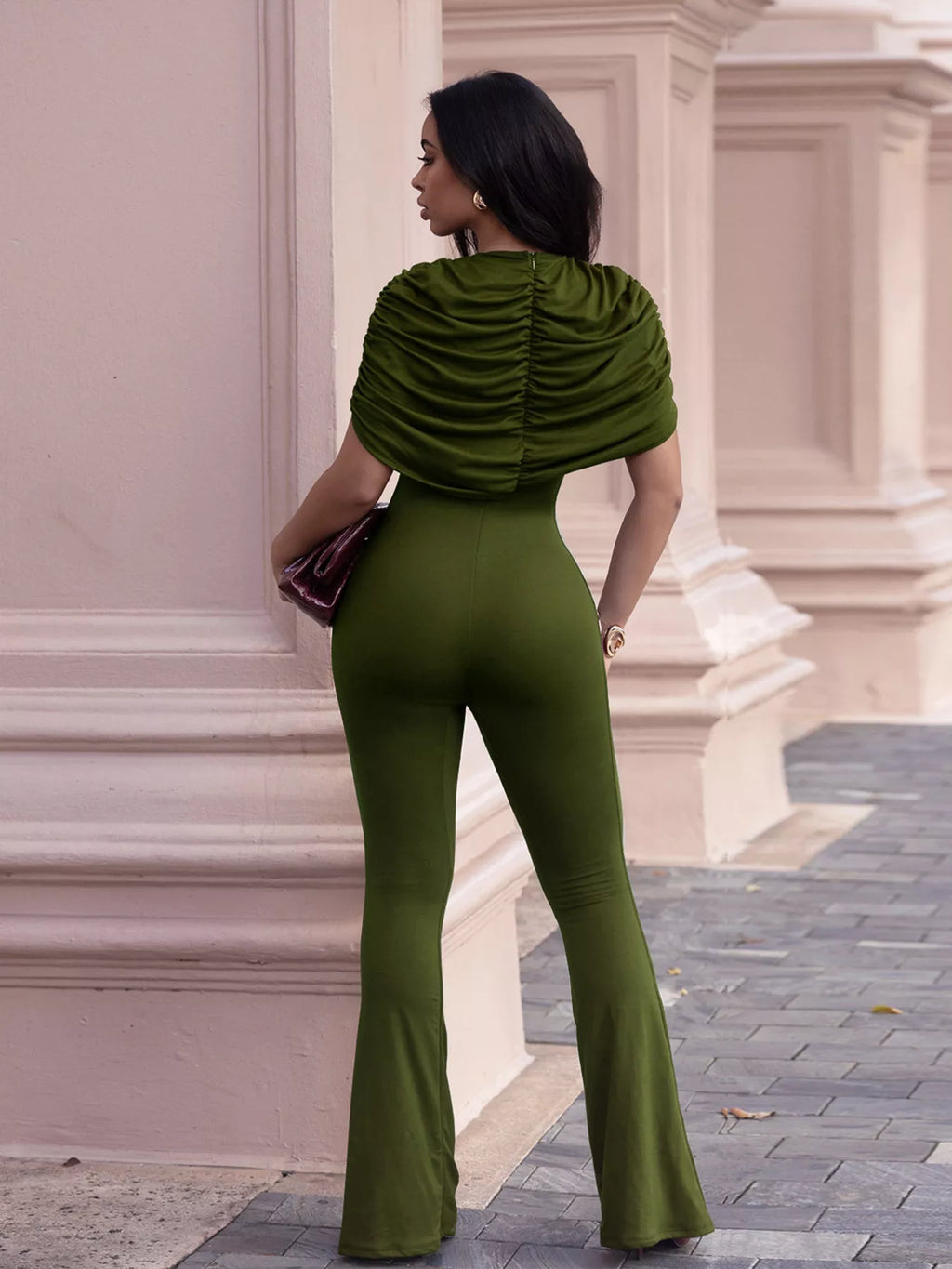 Trendsi ruched flare-leg jumpsuit with fitted bodice and wide leg design, shown in black fabric on a model.