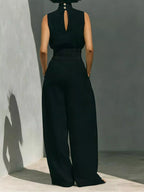 Sleeveless turtleneck top and wide-leg pants set by Trendsi, featuring a sleek, stylish look with neutral tones and comfortable fit.