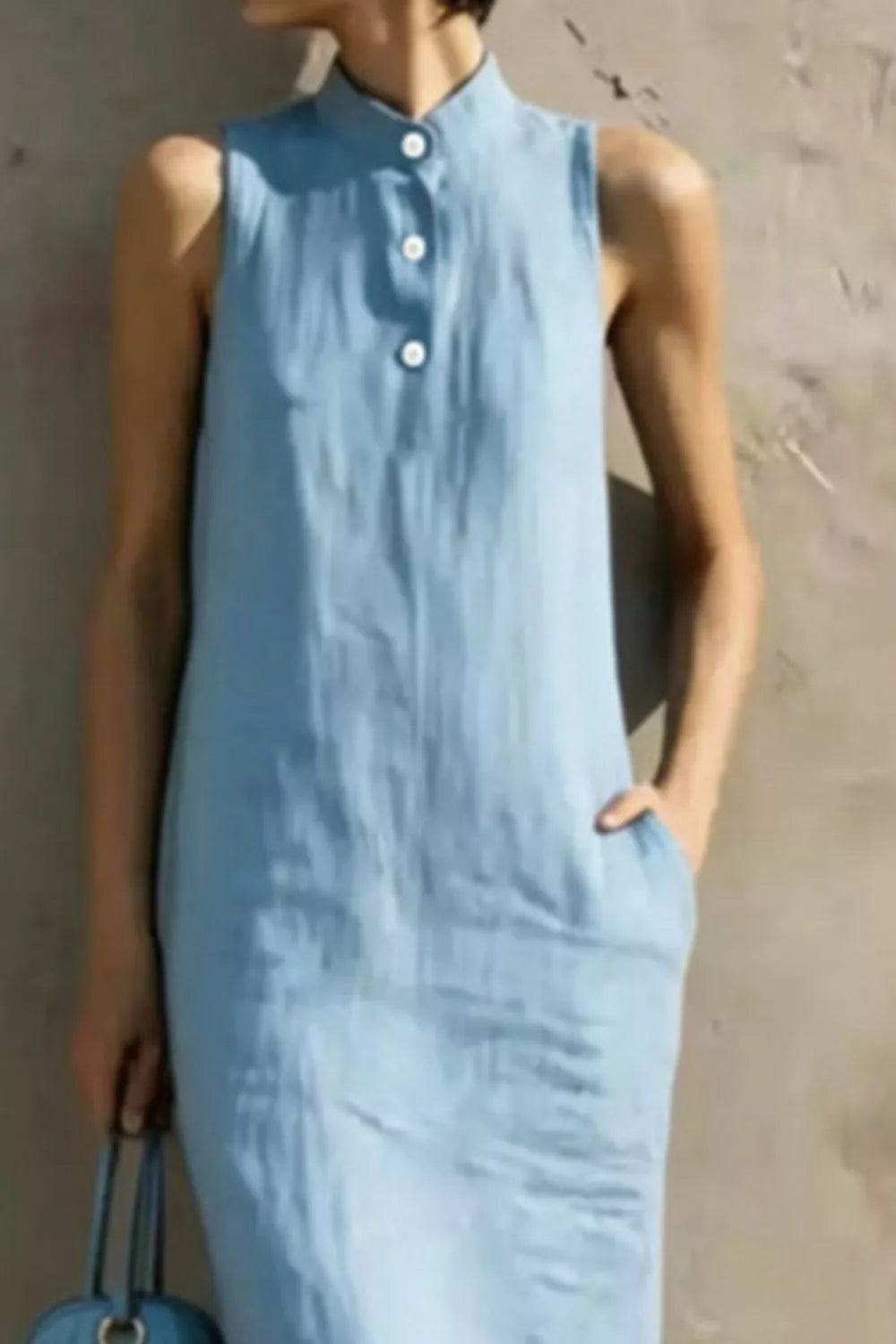 Casual sleeveless midi dress by Trendsi with button details, lightweight fabric, and a relaxed fit, ideal for warm-weather wear.