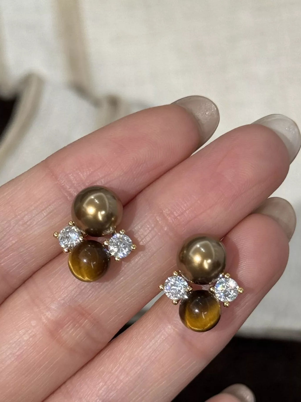 Tiger Eye stud earrings by Trendsi featuring polished oval gemstones set in silver-tone metal.