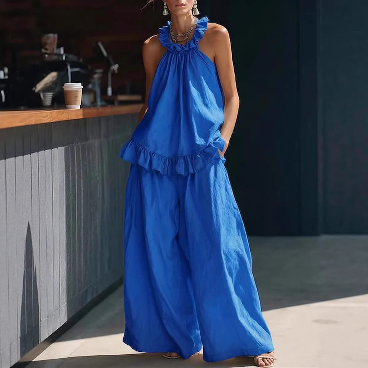 Halterneck loose two-piece casualwear set by FitiqueFit with pleated fabric and asymmetric pocket design, shown on a model.