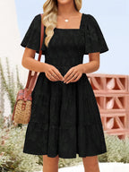Women's smocked tiered square neck short sleeve casual dress with pockets, stylish and comfortable from Trendsi.
