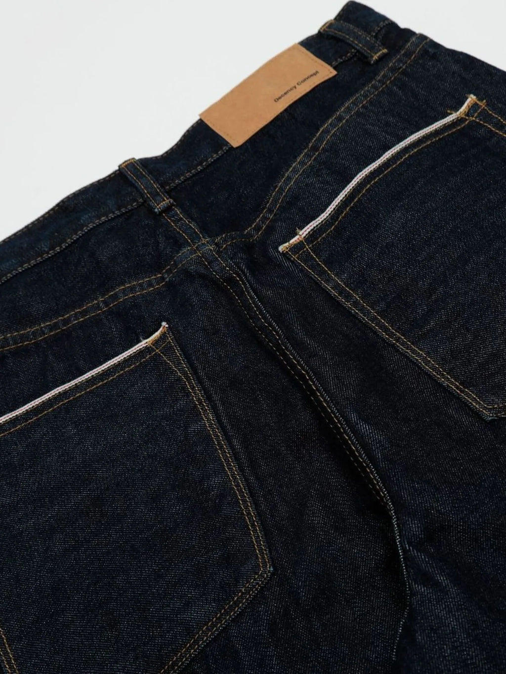 Men's wide leg denim jeans by Plush Fashion Shop, showing the relaxed fit and classic indigo wash on a hanger.